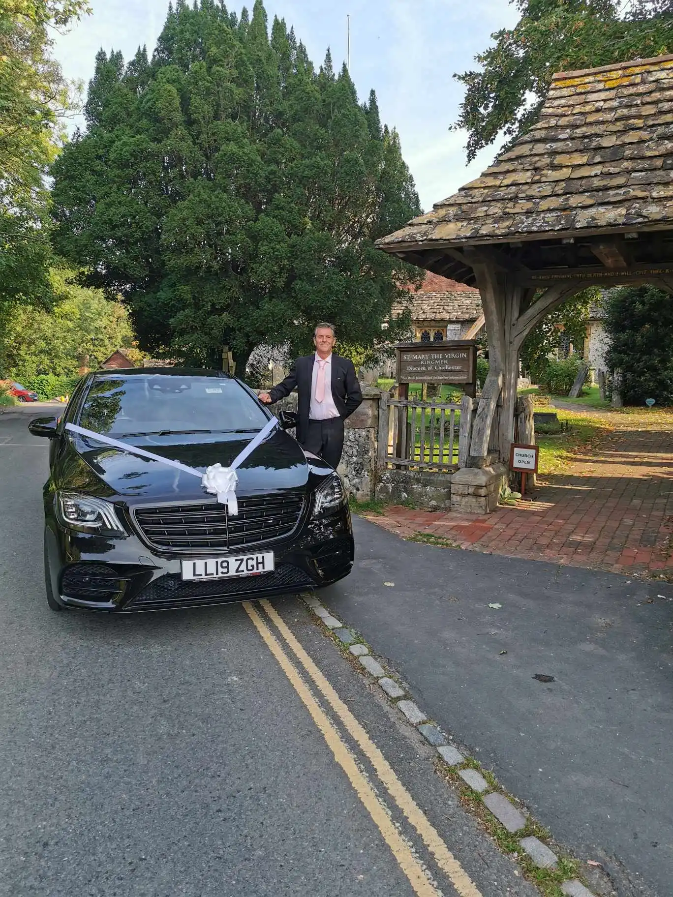 driver waiting outside with wedding cab