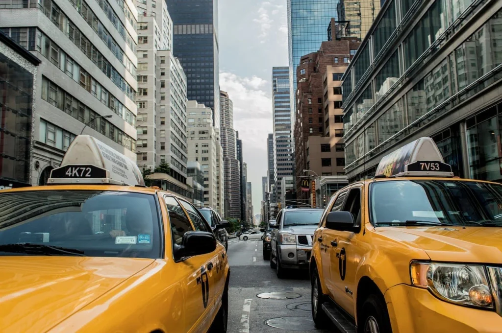 Yellow cabs in city traffic for long distance taxi service
