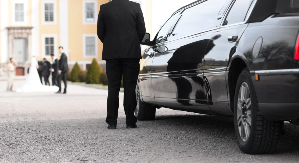 Groom stepping out of a classic wedding cab